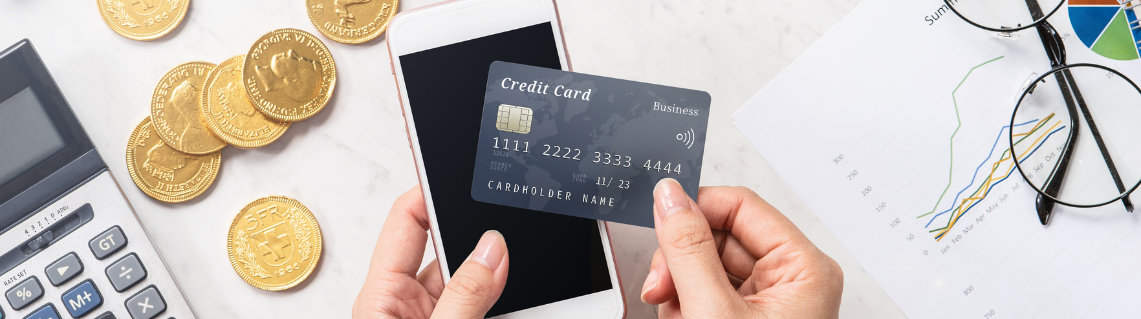 Image of credit card making a payment via a mobile phone